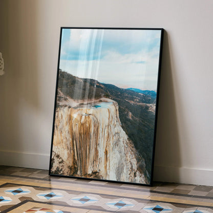 Majestic mountain landscape poster with rocky cliffs and blue sky wall art in black frame.