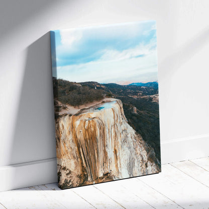 Mountain cliff canvas wall art featuring a stunning sunset over rugged terrain.