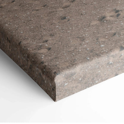 Close-up of textured brown canvas wall art corner with speckled, weathered appearance.