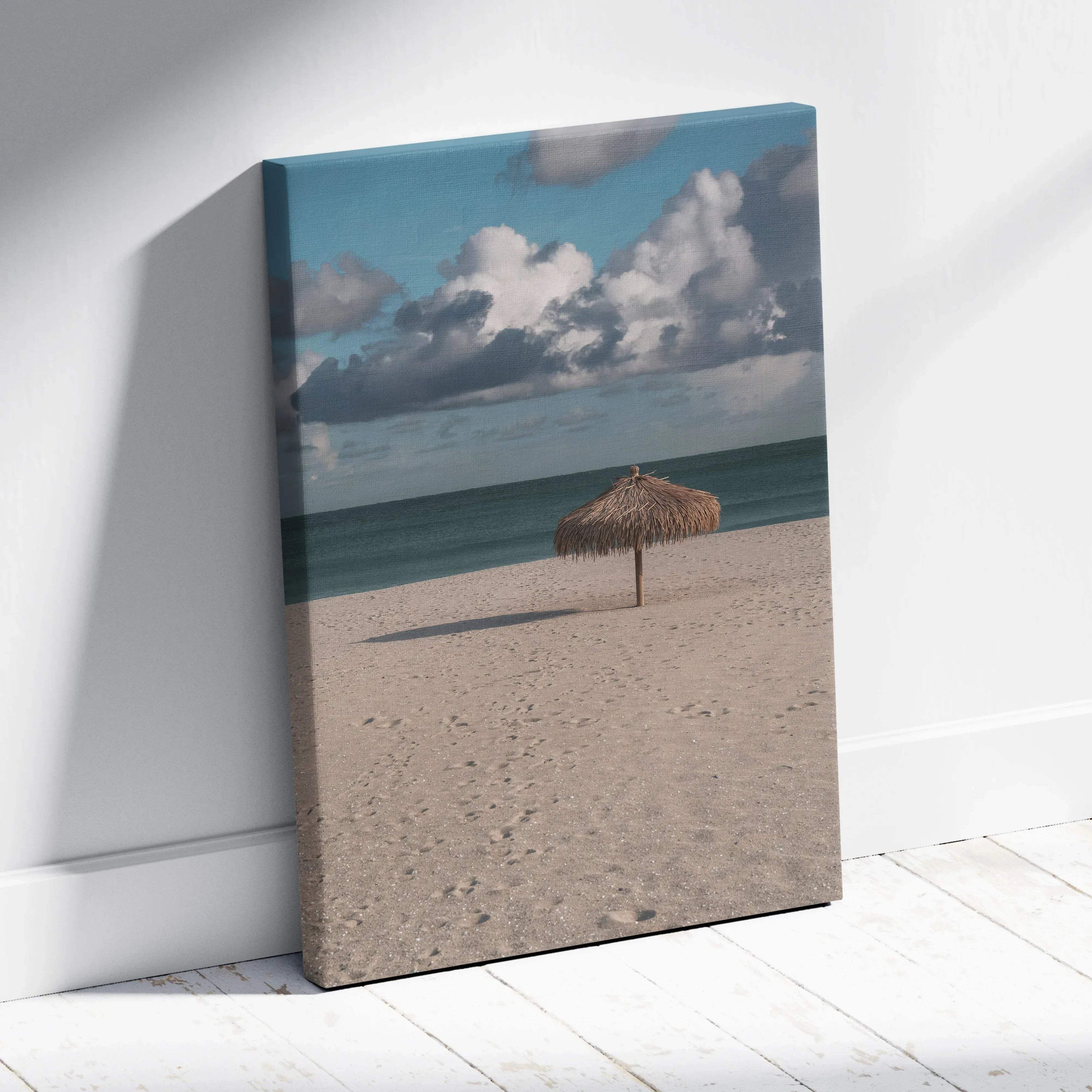 Canvas wall art of beach scene with sandy shore, calm ocean, and dramatic cloudy sky.