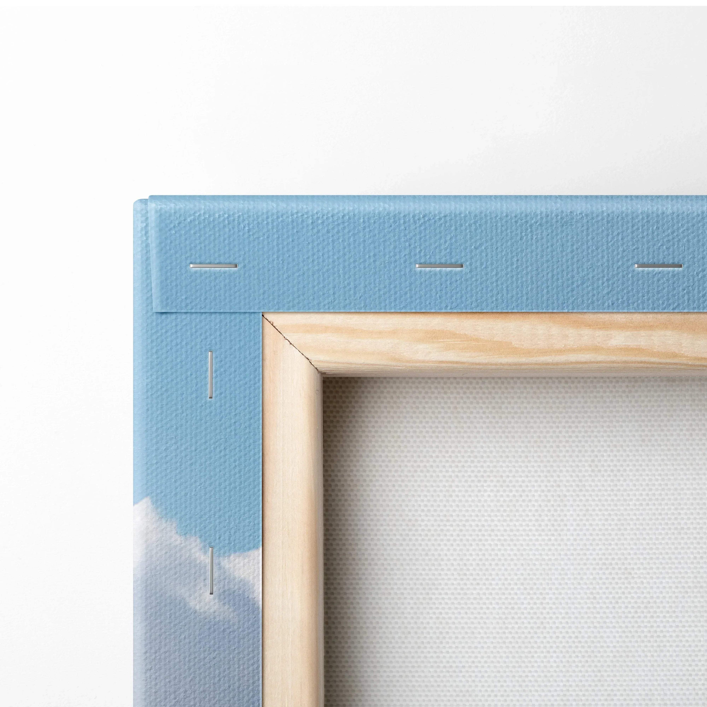 Close-up of wooden frame corner with blue canvas stretched and stapled for wall art display.