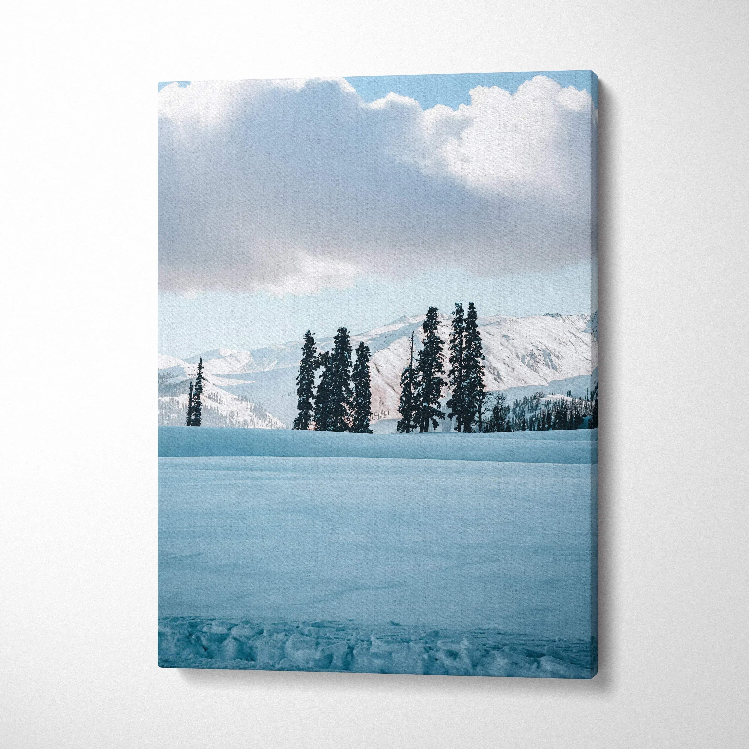 Vertical snowy mountain landscape with tall pine trees under cloudy sky canvas wall art.