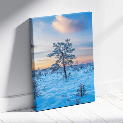 Canvas wall art featuring a snowy landscape with a single tree under a colorful sunset sky.