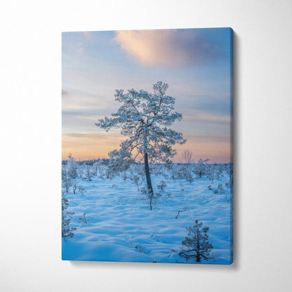 Vertical snowy landscape canvas wall art featuring lone tree at sunset with soft pastel sky.