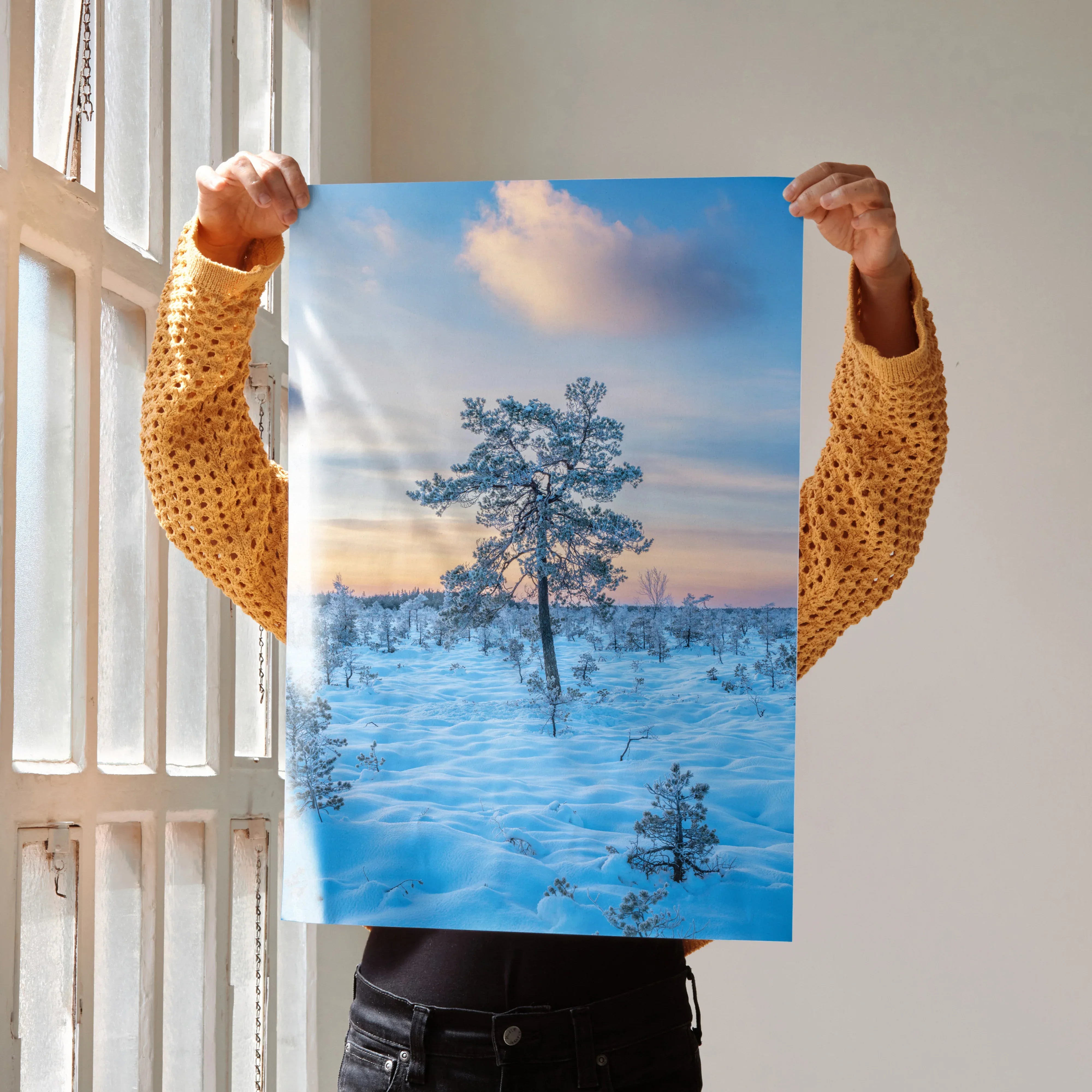 Serene snowy landscape poster featuring a lone tree under a blue sky, winter wall art.