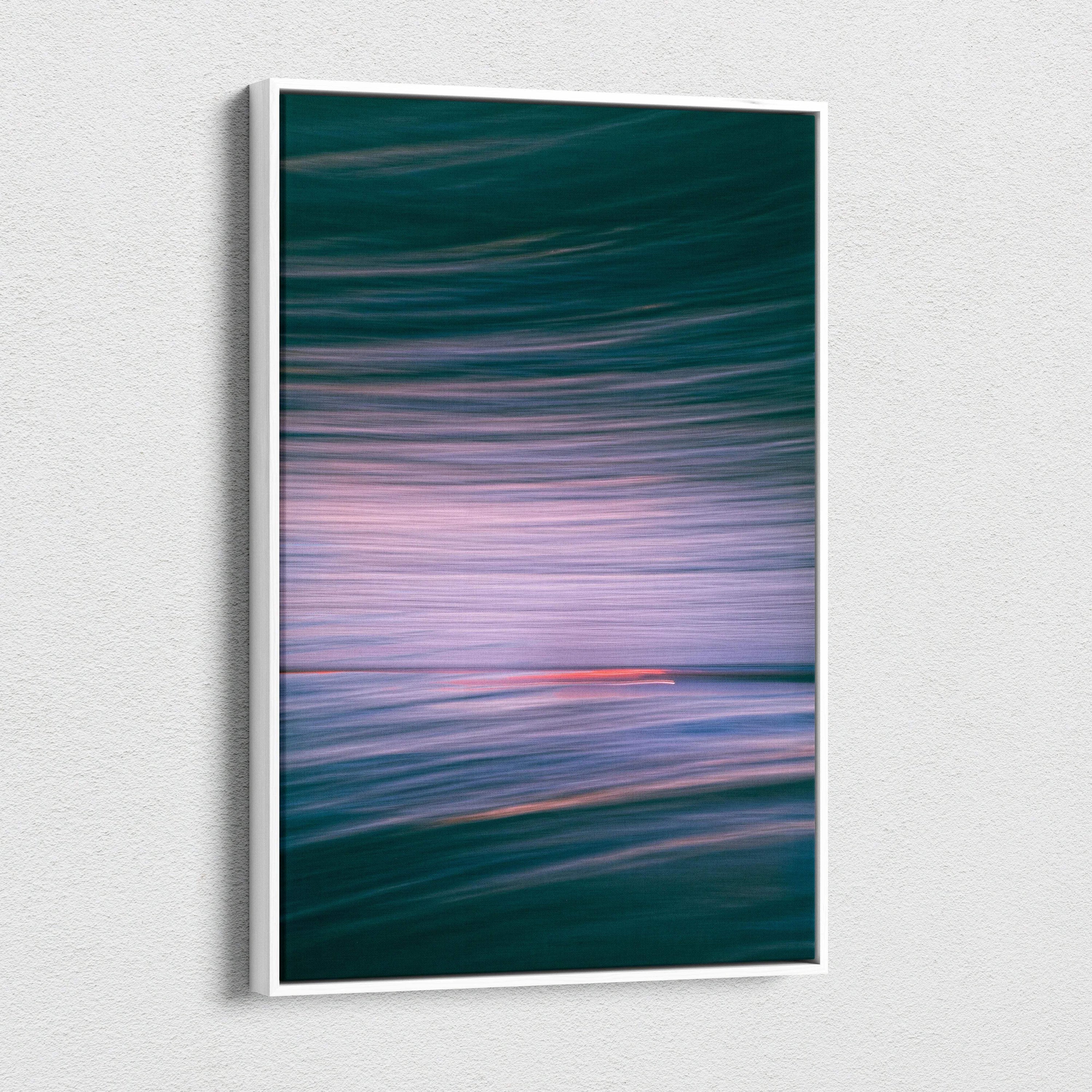 Framed abstract ocean canvas wall art with teal waves and pink sunset motion blur