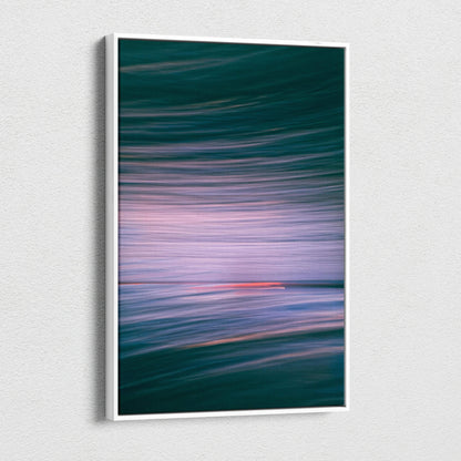 Framed abstract ocean canvas wall art with teal waves and pink sunset motion blur