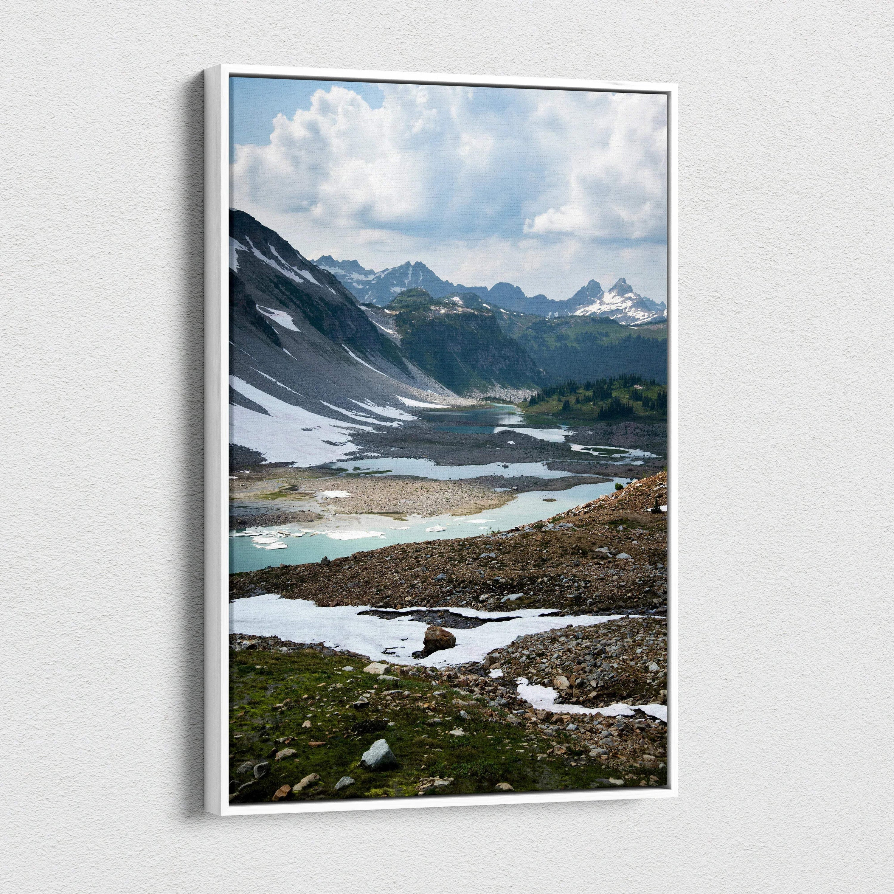 Mountain landscape with snow patches and cloudy sky on canvas wall art.
