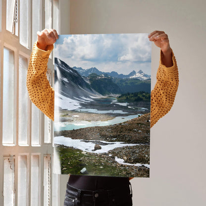 Vertical mountain landscape poster with snow patches and rocky terrain, nature wall art.