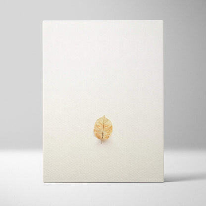 Minimalist golden-brown pressed leaf on warm beige canvas wall art