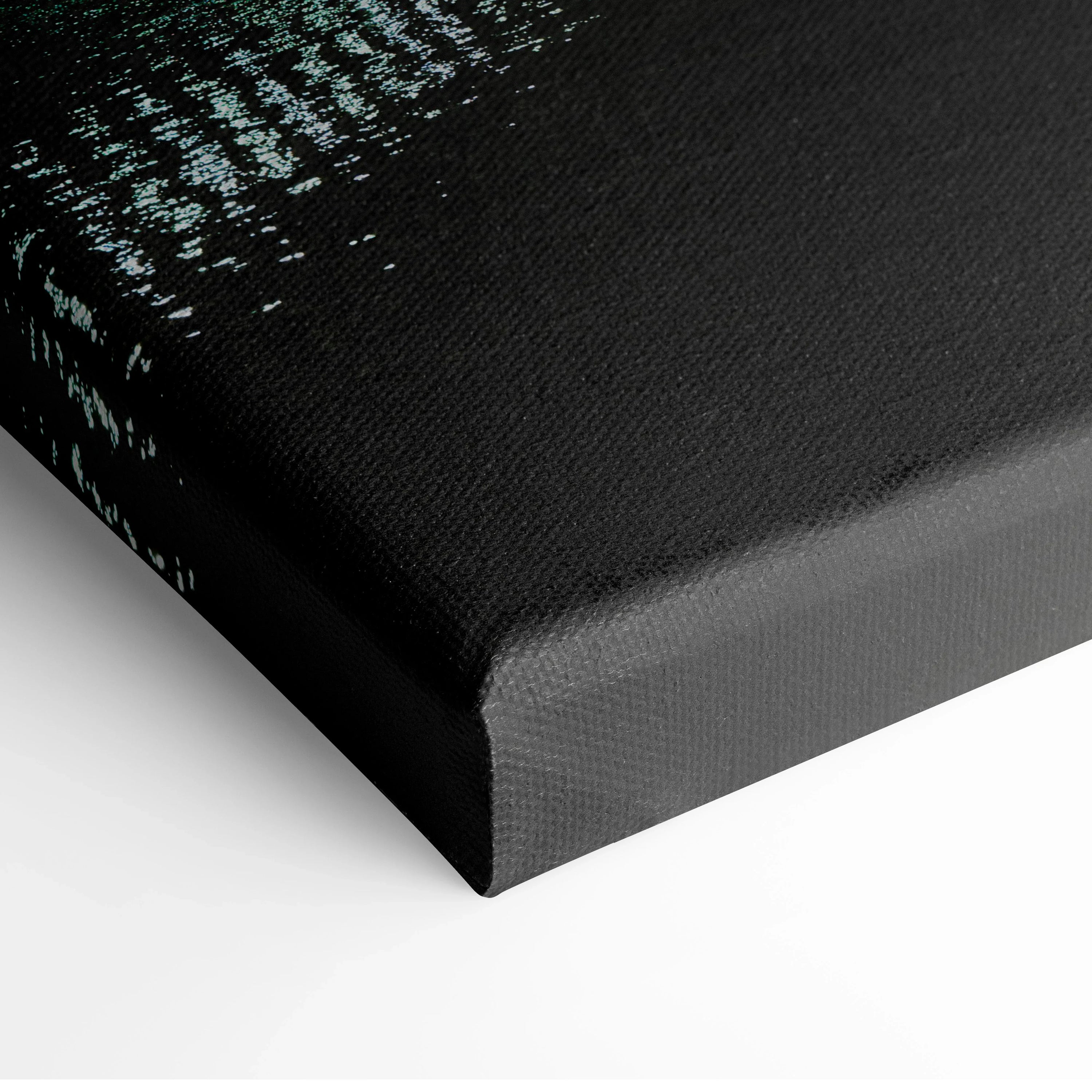 Close-up of black canvas edge with textured city skyline detail in wall art.
