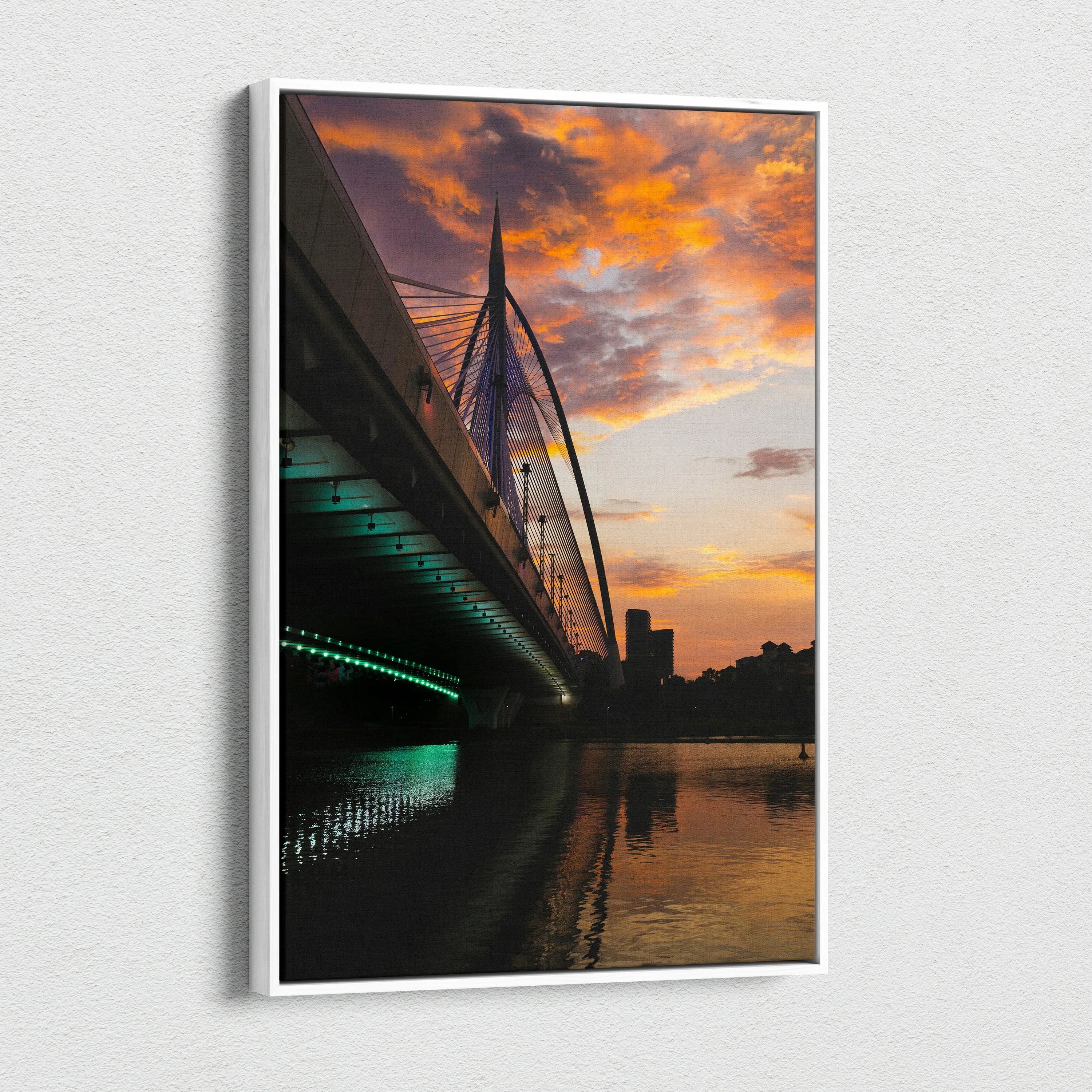 Canvas wall art of city skyline at golden sunset with illuminated bridge and reflective water.
