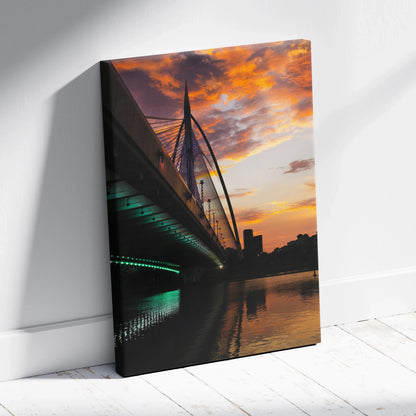 Golden sunset city skyline with illuminated bridge reflected in water canvas wall art.