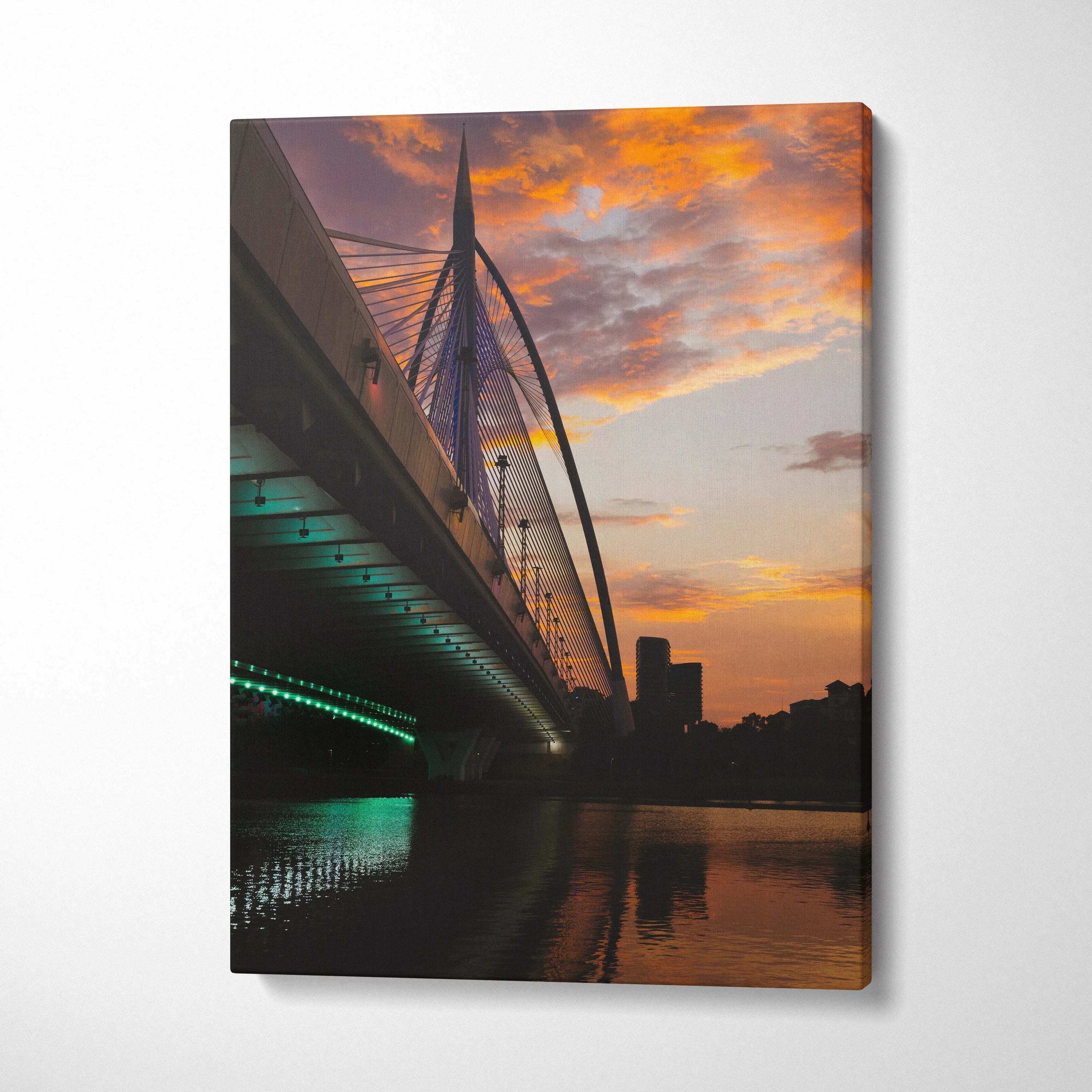 Vertical canvas wall art of city skyline at golden sunset with illuminated bridge over river.