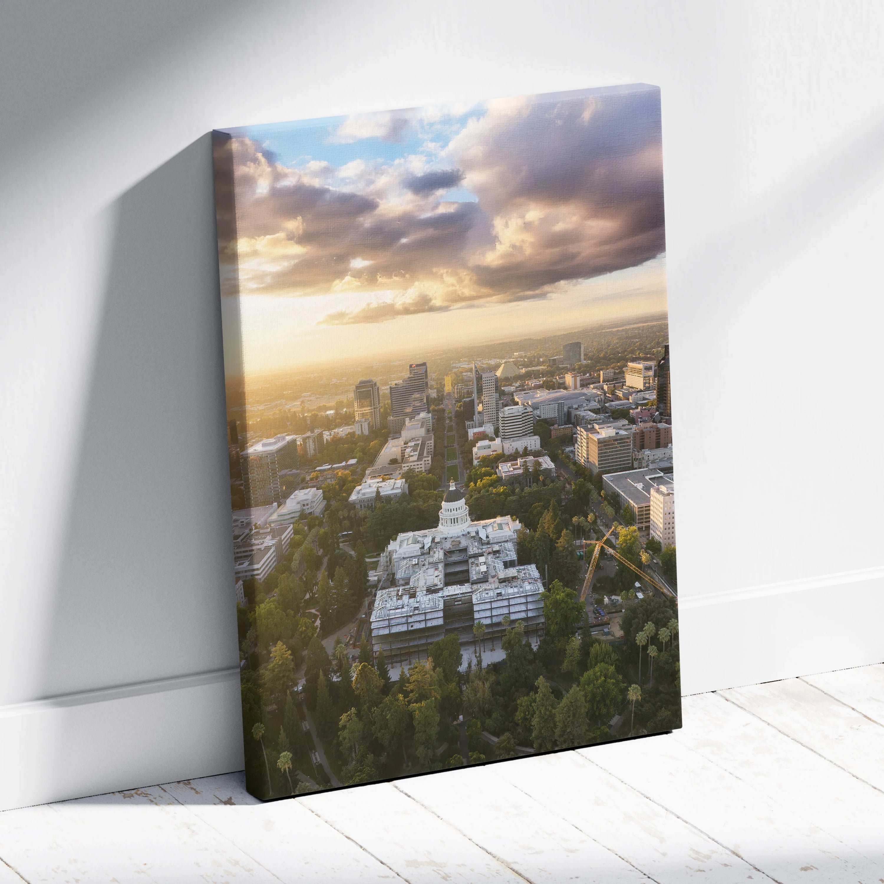 Canvas wall art featuring a city skyline at sunset with colorful clouds and urban buildings.