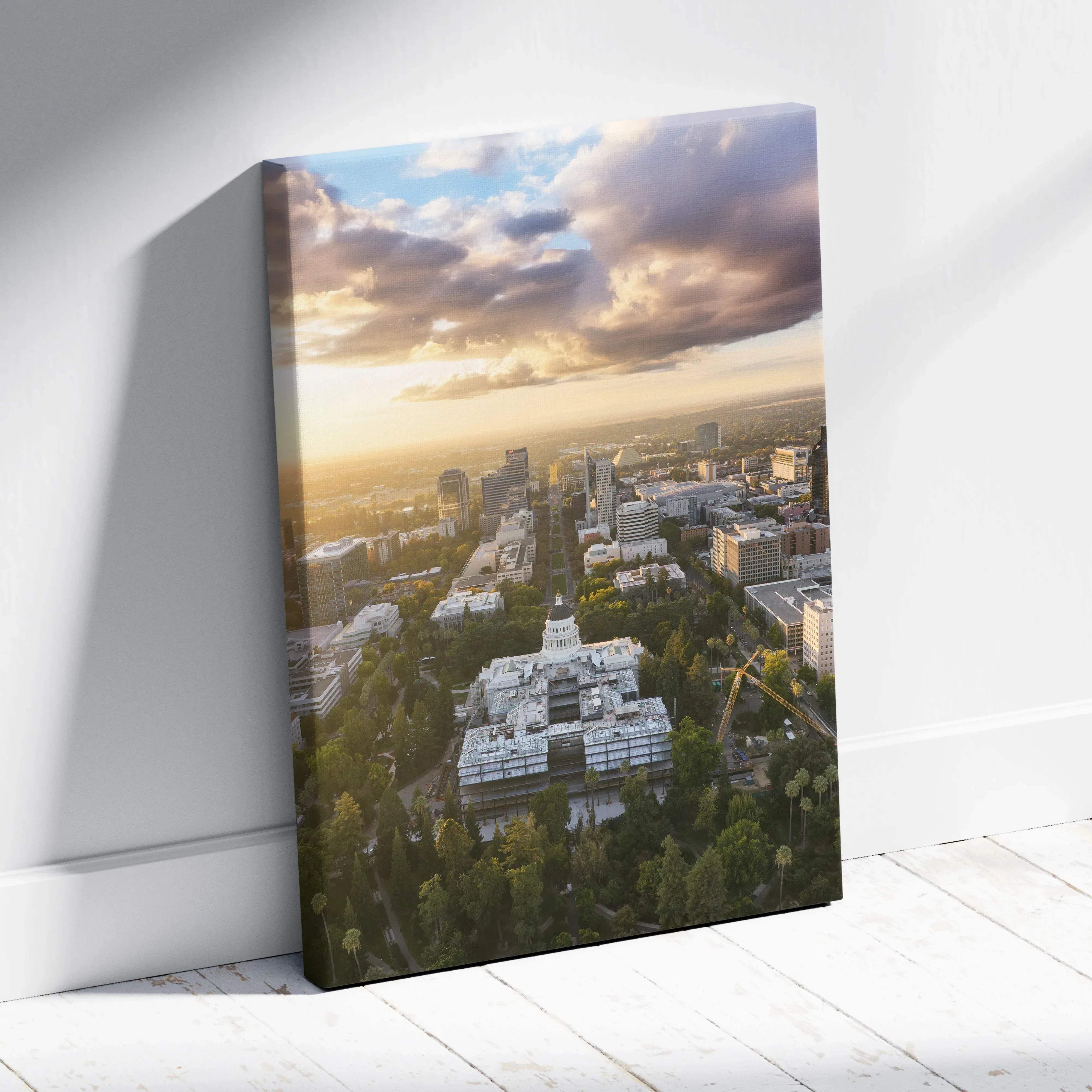 Rectangular canvas print of an aerial cityscape with a white building and greenery under a dramatic sunset sky for modern living rooms
