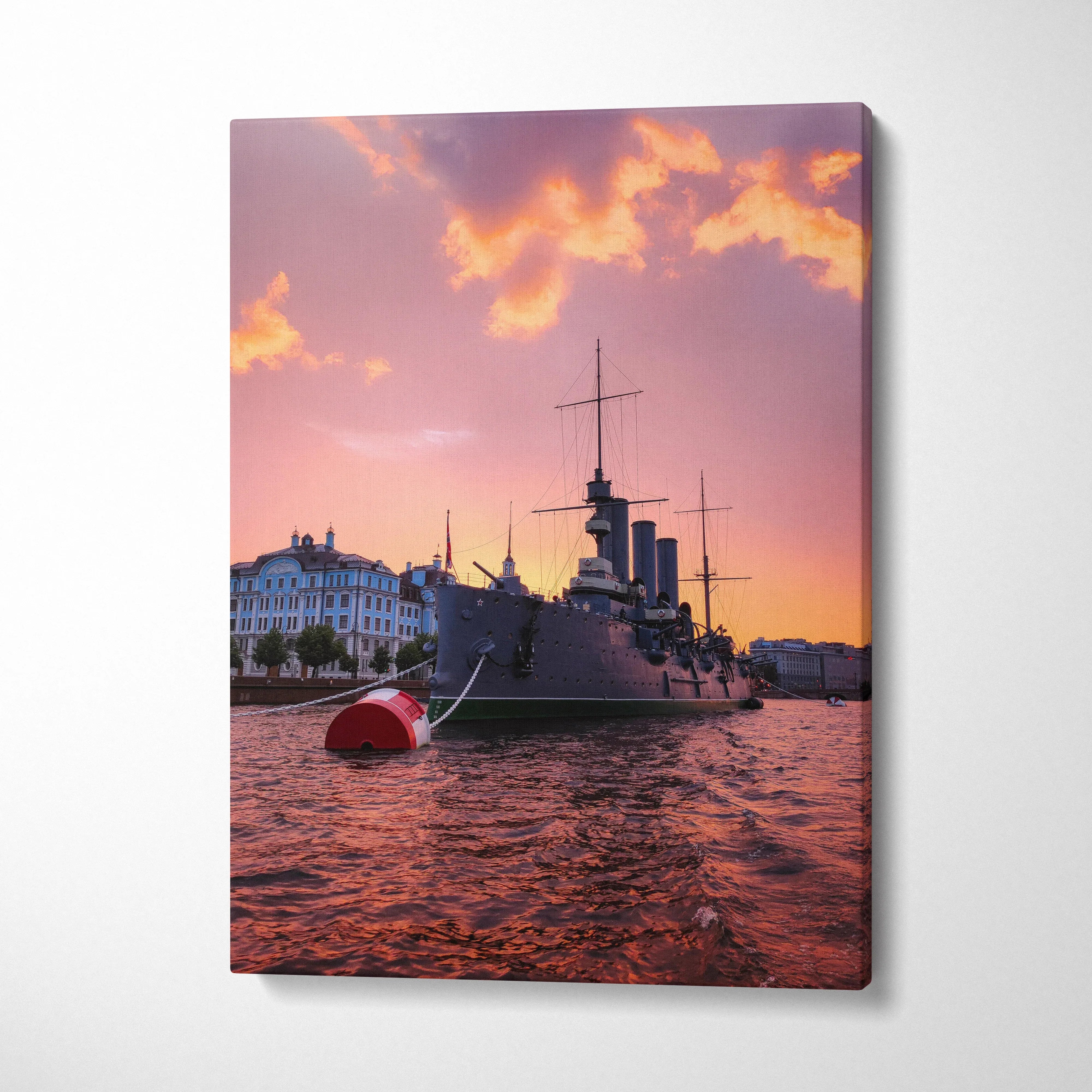Canvas wall art depicting a city harbor with a large ship at sunset and vibrant orange sky.