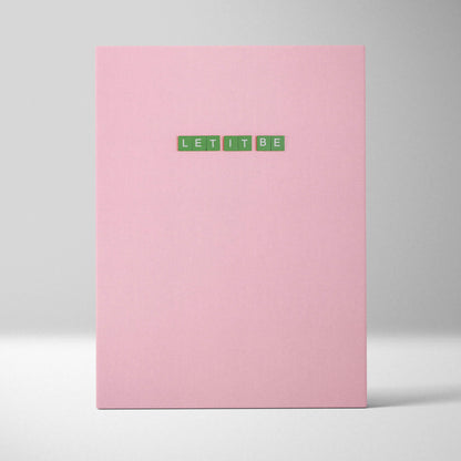 Pink hardcover notebook with green Let It Be tile letters on cover