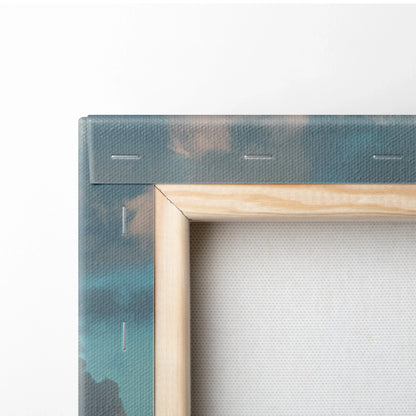 Close-up of stretched canvas wall art with city sunset colors and wooden frame edges.