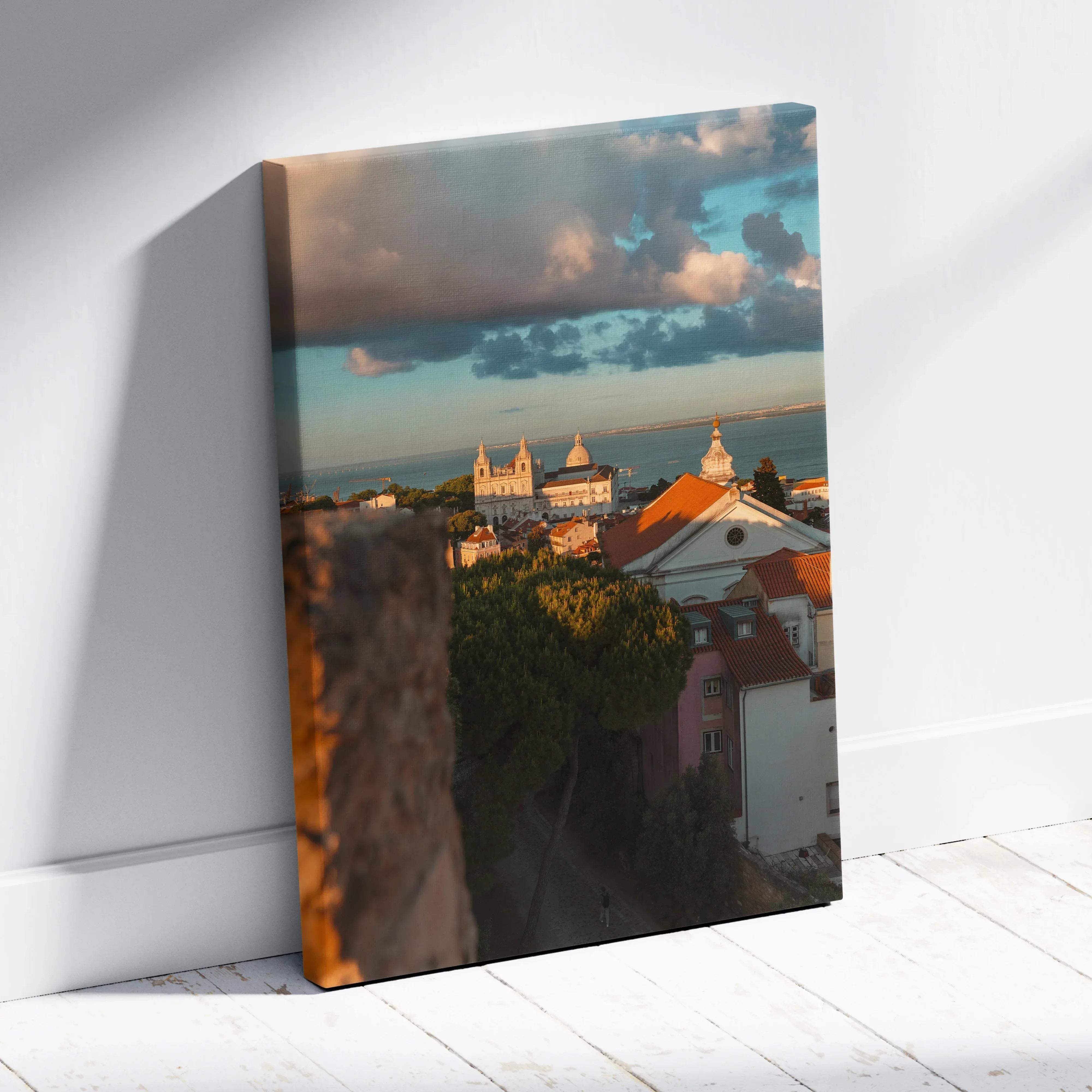 Rectangular canvas print of coastal rooftops and cathedral with orange-tiled roofs under a warm golden hour sky mounted on white wall