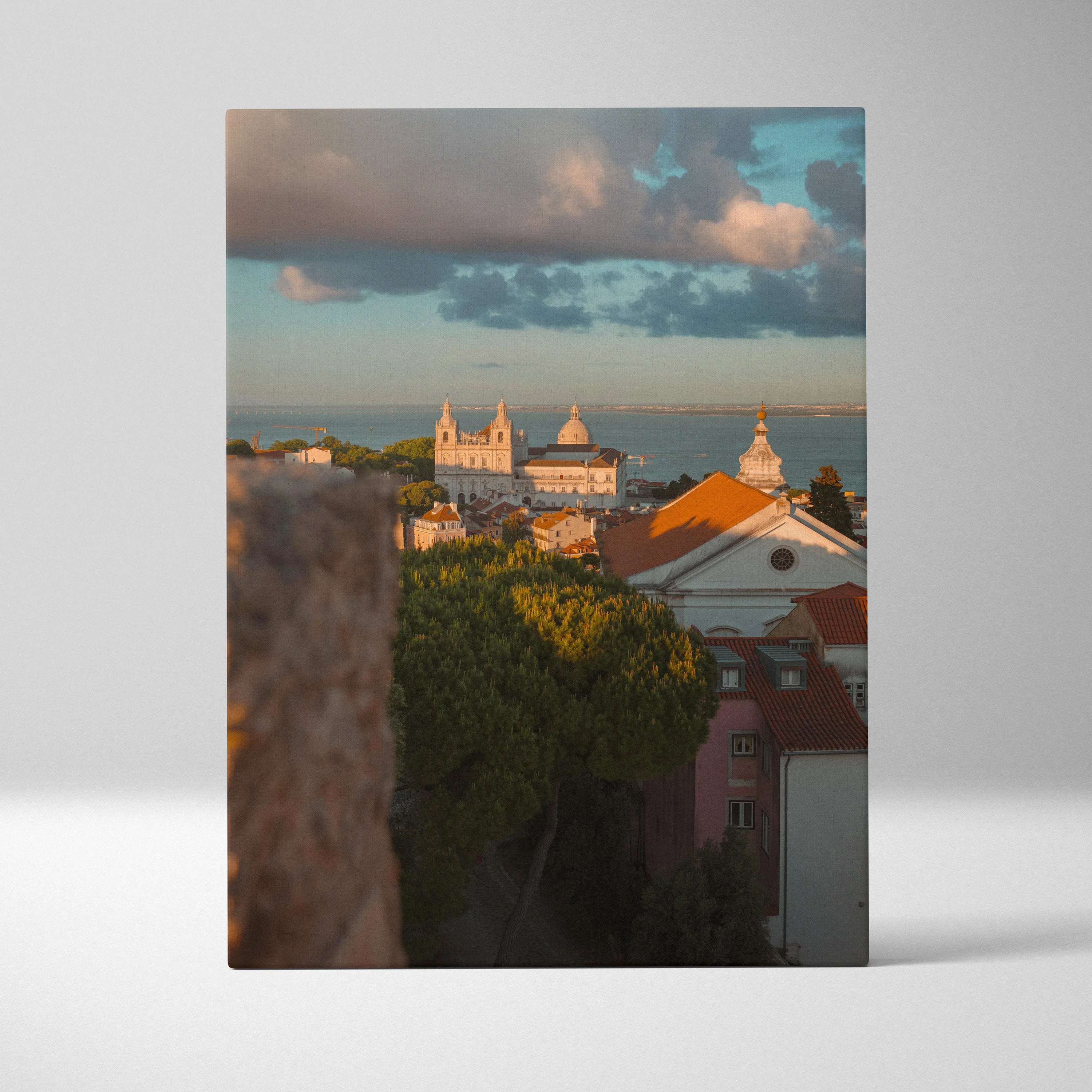 Vertical canvas wall art featuring a cityscape at sunset with buildings and soft clouds.