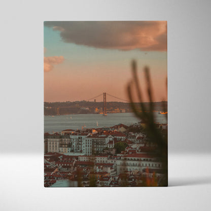 Vertical canvas wall art featuring a sunset over a cityscape with a distant bridge and warm sky colors.