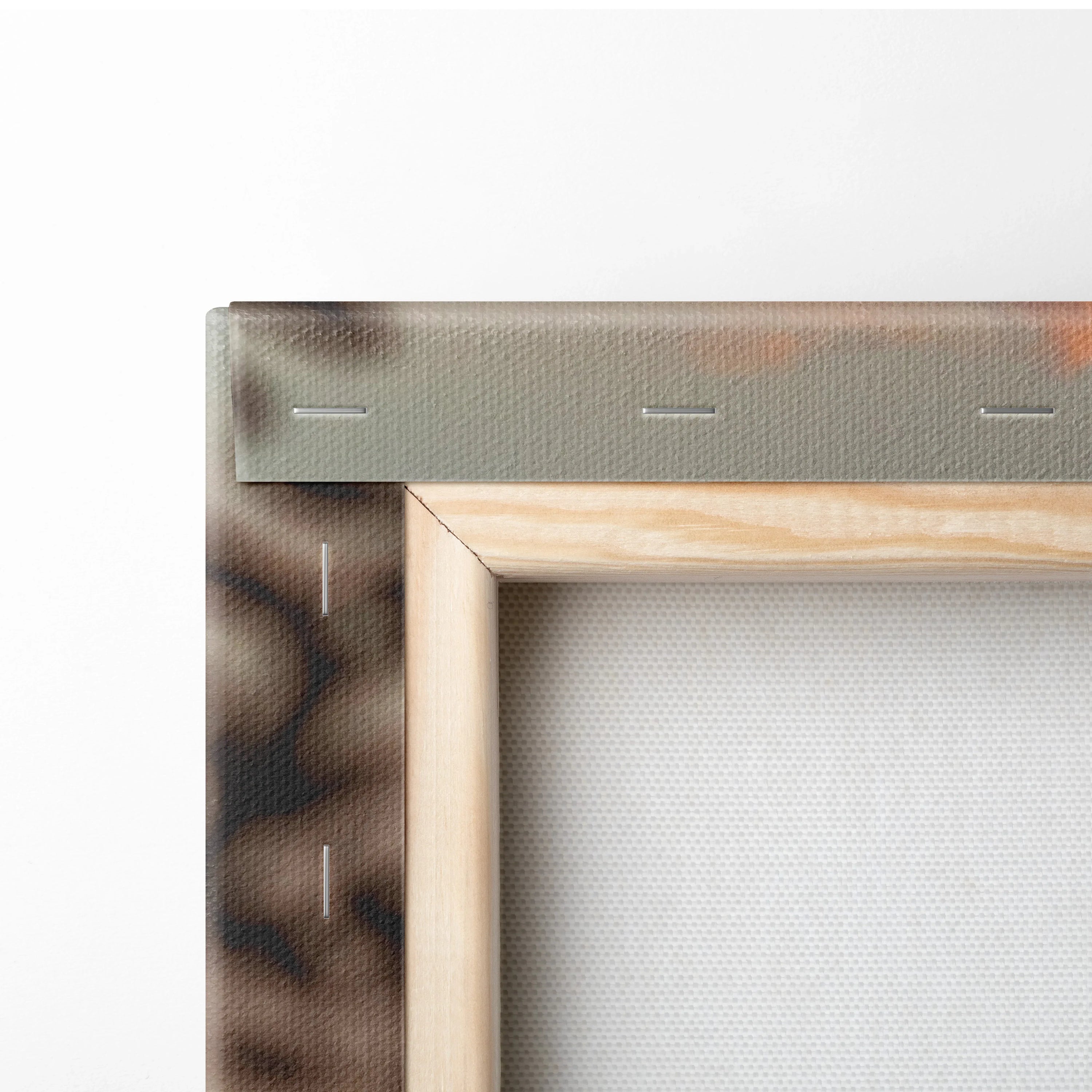 Close-up of wooden stretcher frame with canvas fabric and stapled edges on wall art canvas panel.