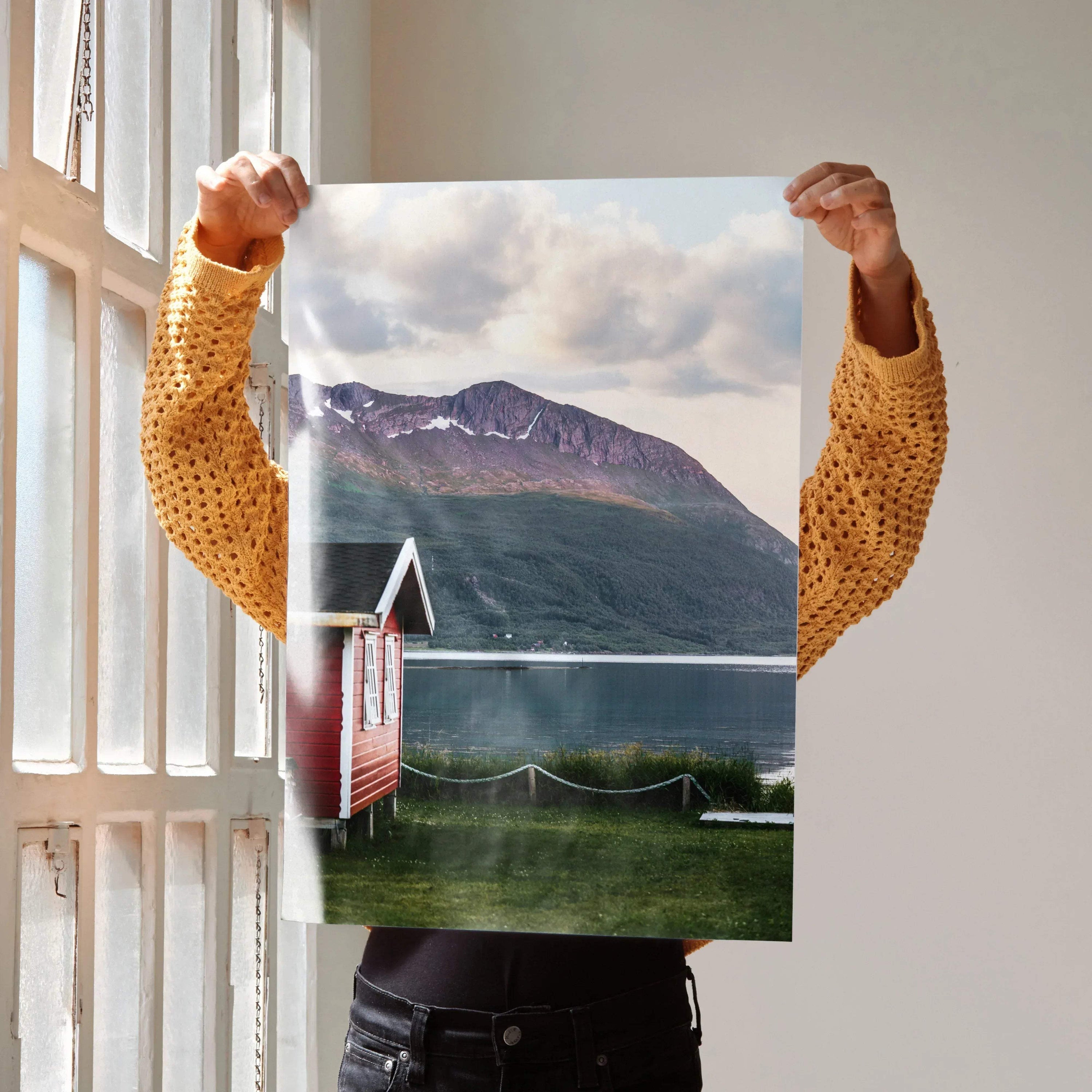 Majestic mountain landscape poster with lake, red cabin, and cloudy sky wall art.