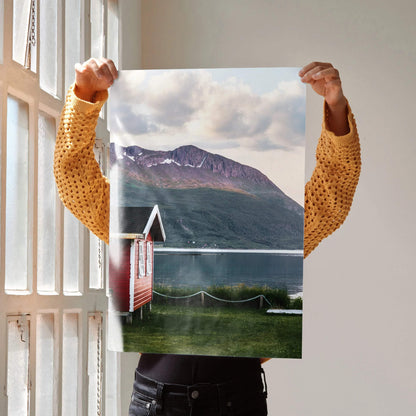Majestic mountain landscape poster with lake, red cabin, and cloudy sky wall art.