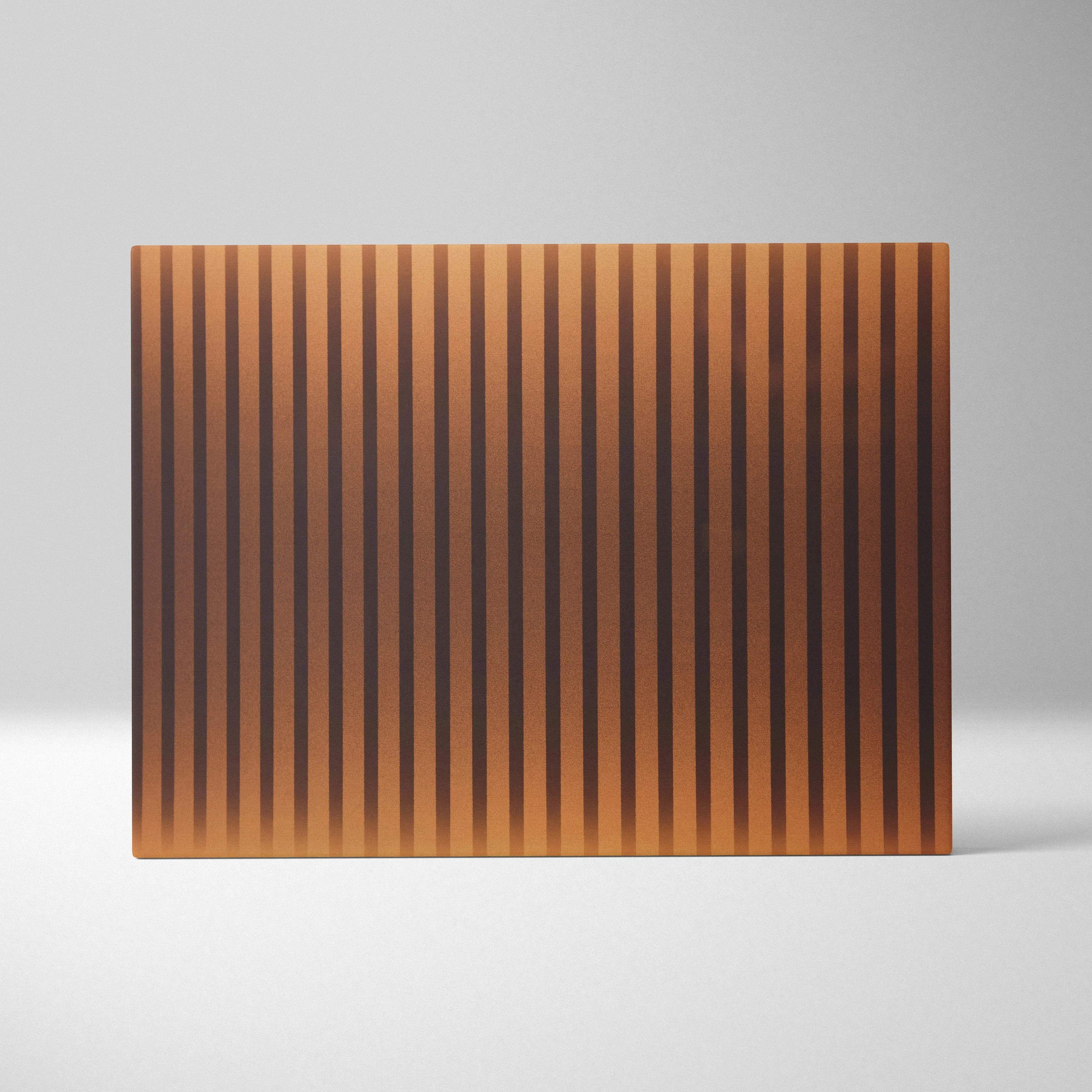 Rectangular copper cutting board with vertical grooves in golden amber tones