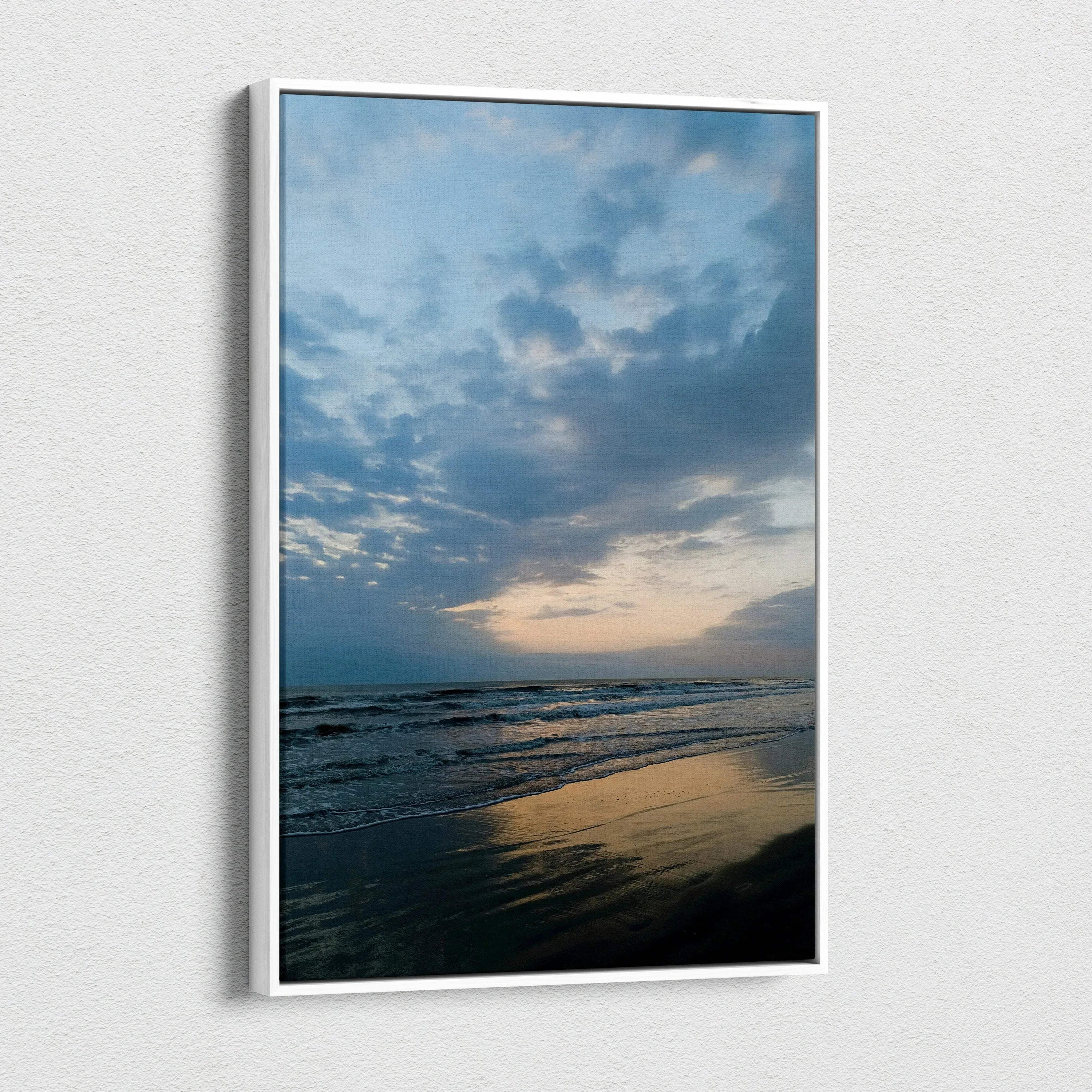 Vertical canvas wall art of a serene beach at sunset with cloudy sky and reflective water.