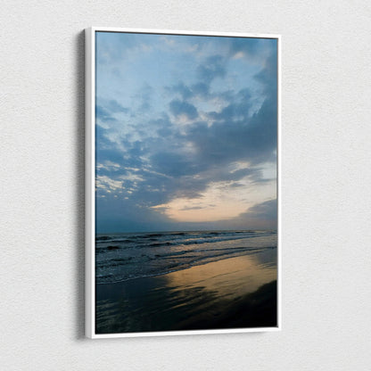 Vertical canvas wall art of a serene beach at sunset with cloudy sky and reflective water.