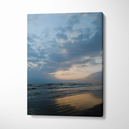 Canvas wall art featuring a serene beach sunset with soft clouds and reflective water.