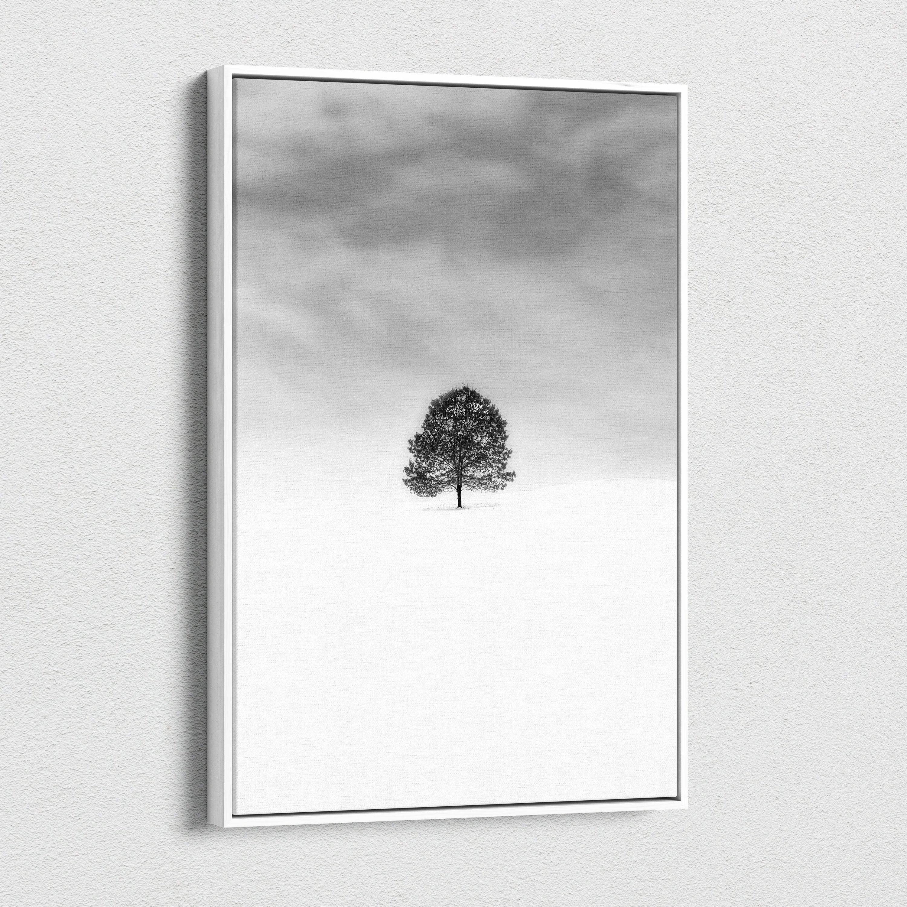Minimalist black and white lone tree in snowy field canvas wall art