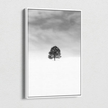 Minimalist black and white lone tree in snowy field canvas wall art