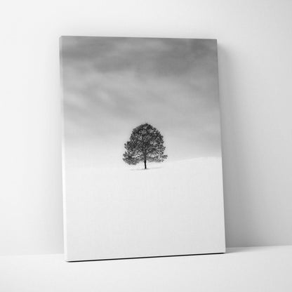 Minimalist black and white lone tree in snowy field canvas print