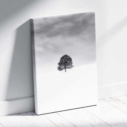 Minimalist black and white lone tree in snowy field canvas print