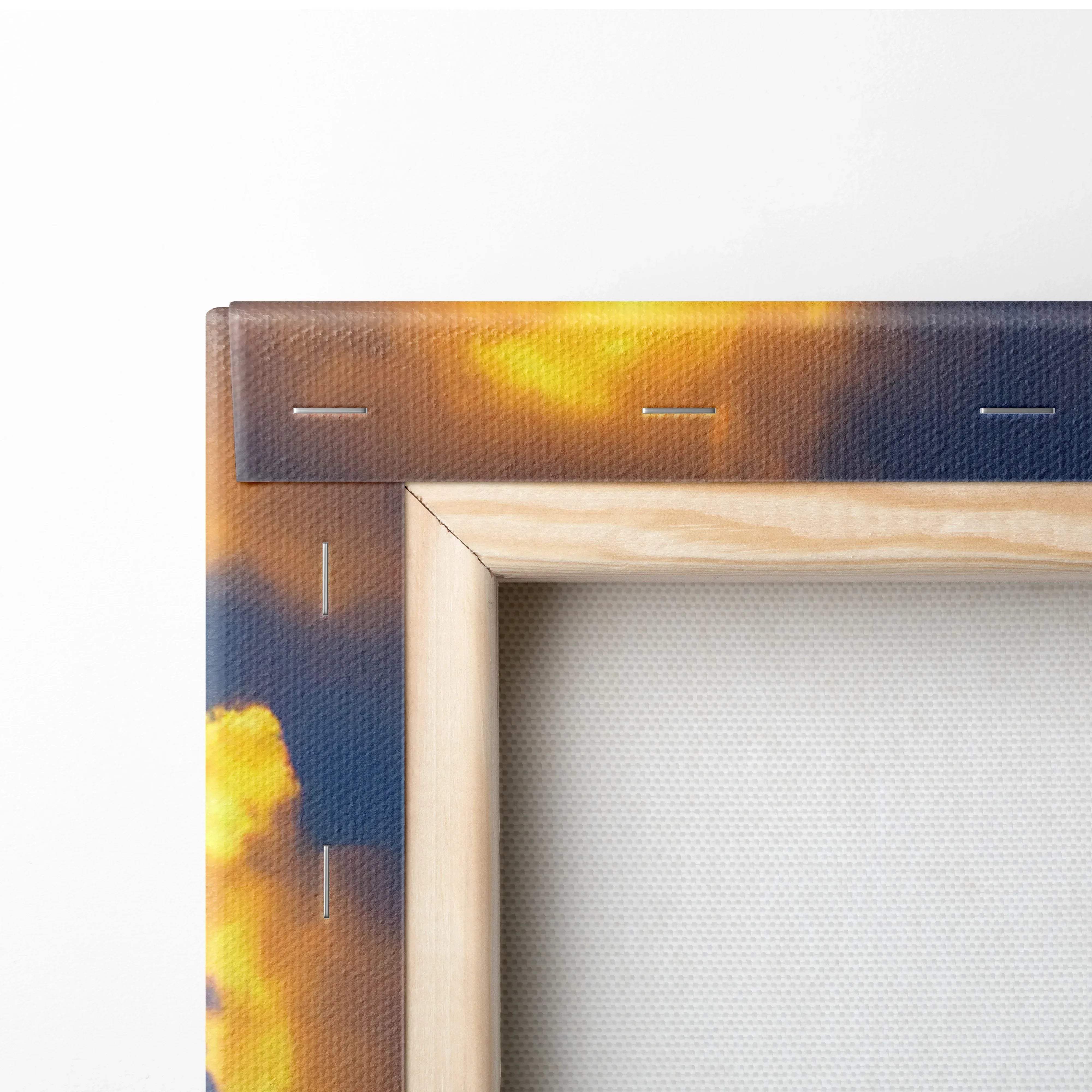 A wooden-framed canvas print of a serene sunset landscape with warm orange and pink hues and stitched edges