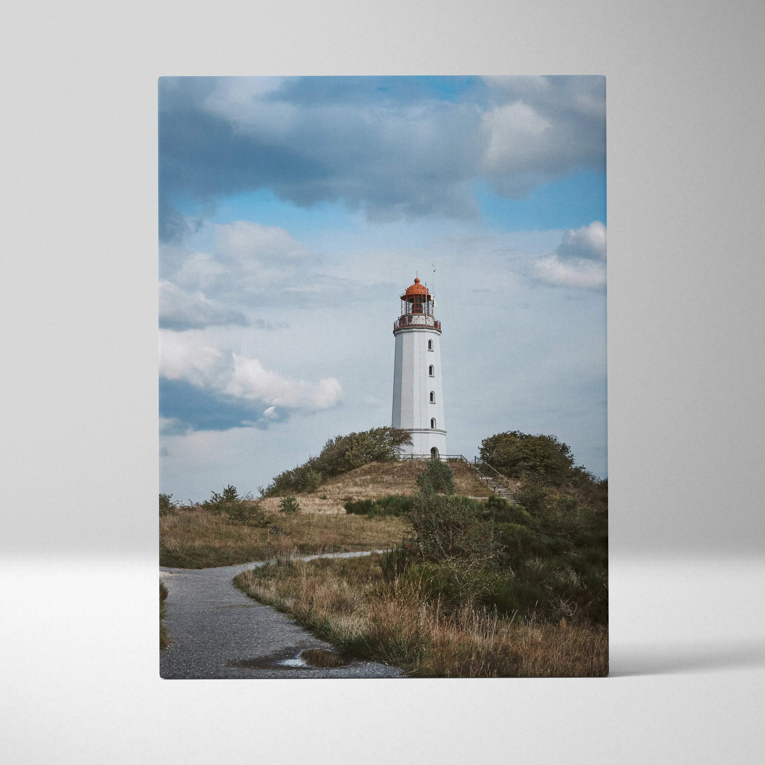 Majestic coastal lighthouse on hill with cloudy sky, vertical canvas wall art print.