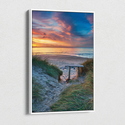 Vertical canvas wall art featuring a serene beach sunset with vibrant clouds and sand dunes.
