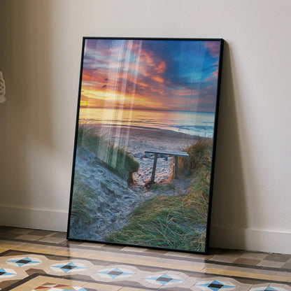 Vibrant beach sunset ocean poster with colorful sky and sandy path wall art in black frame.