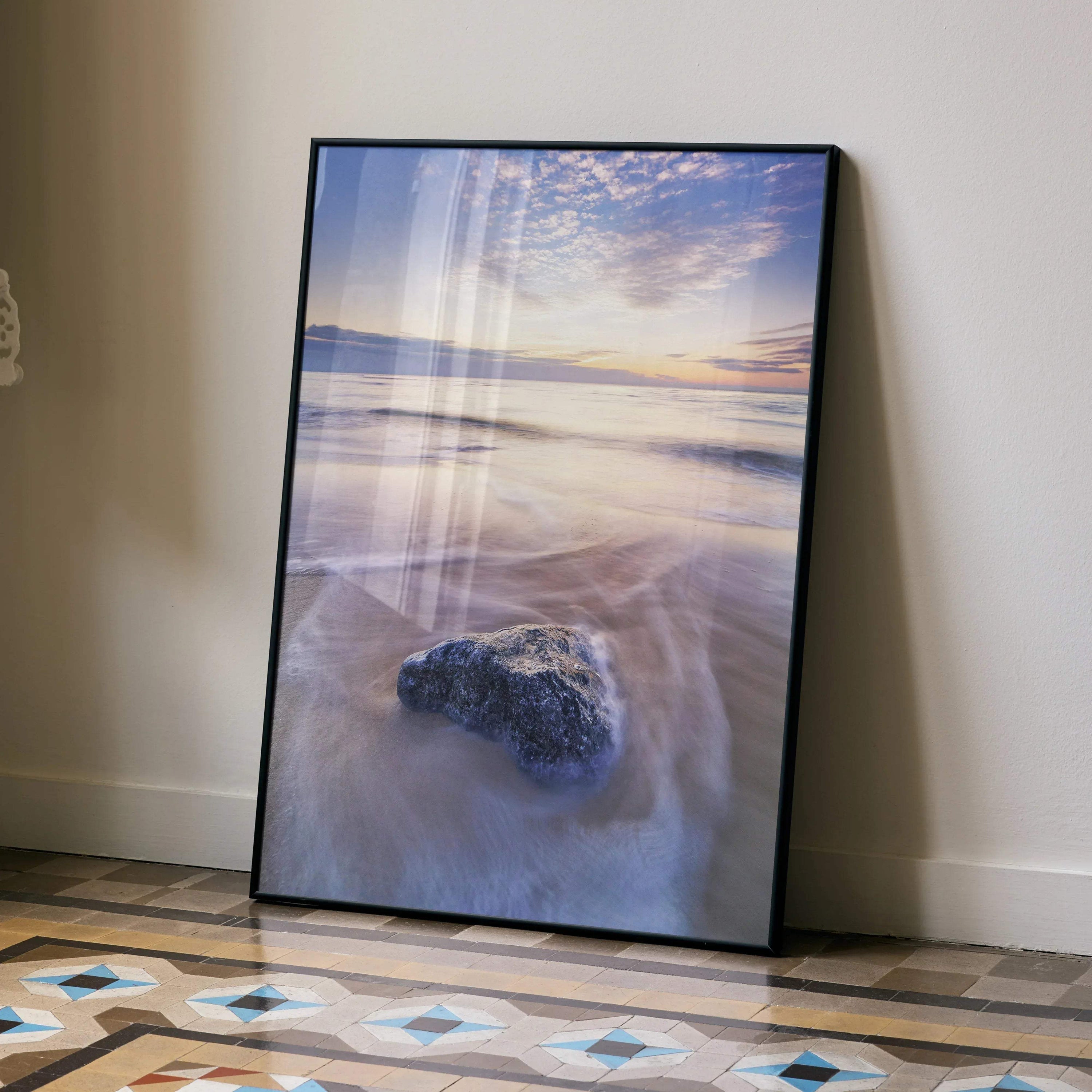 Vibrant beach sunset ocean poster with soft waves and colorful sky wall art in black frame.