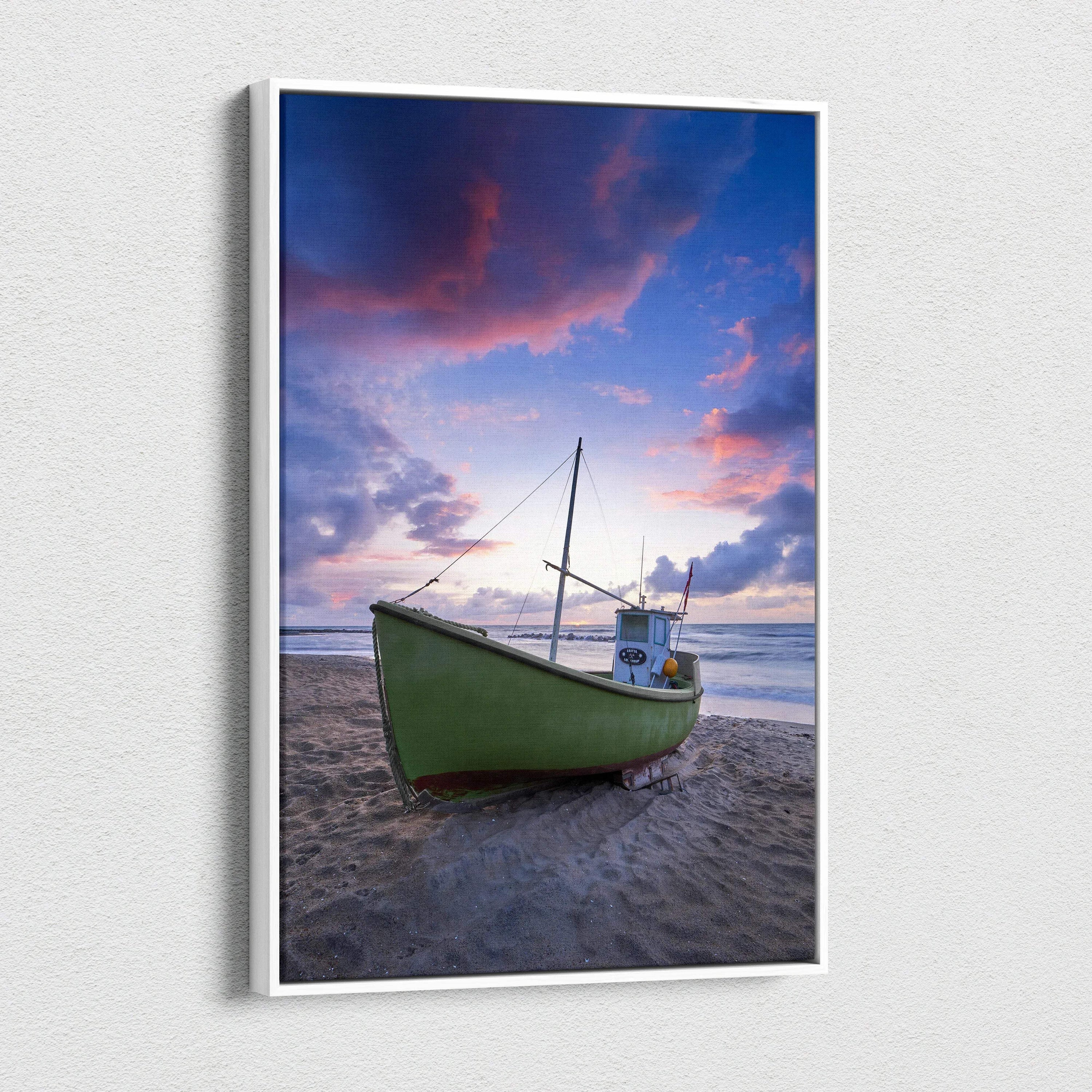 Vertical canvas wall art featuring a green boat on a sandy beach under a colorful sunset sky.