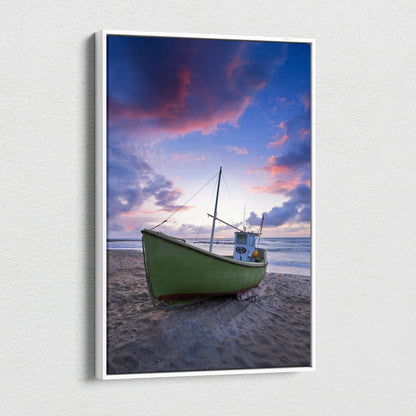 Vertical canvas wall art featuring a green boat on a sandy beach under a colorful sunset sky.