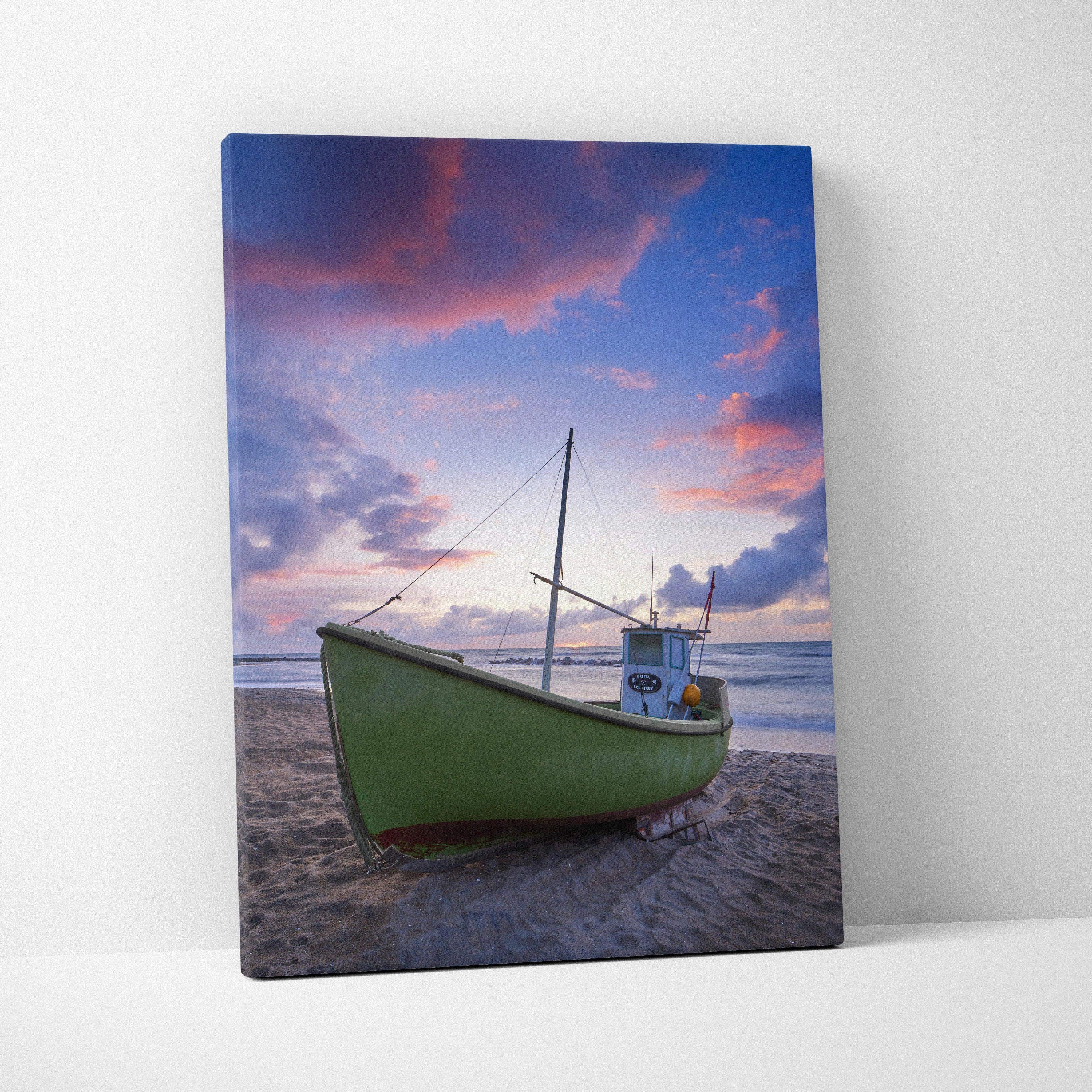 Canvas wall art featuring a green boat on a sandy beach under a vibrant sunset sky.