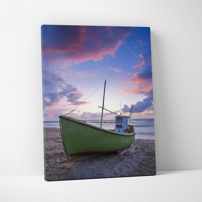 Canvas wall art featuring a green boat on a sandy beach under a vibrant sunset sky.
