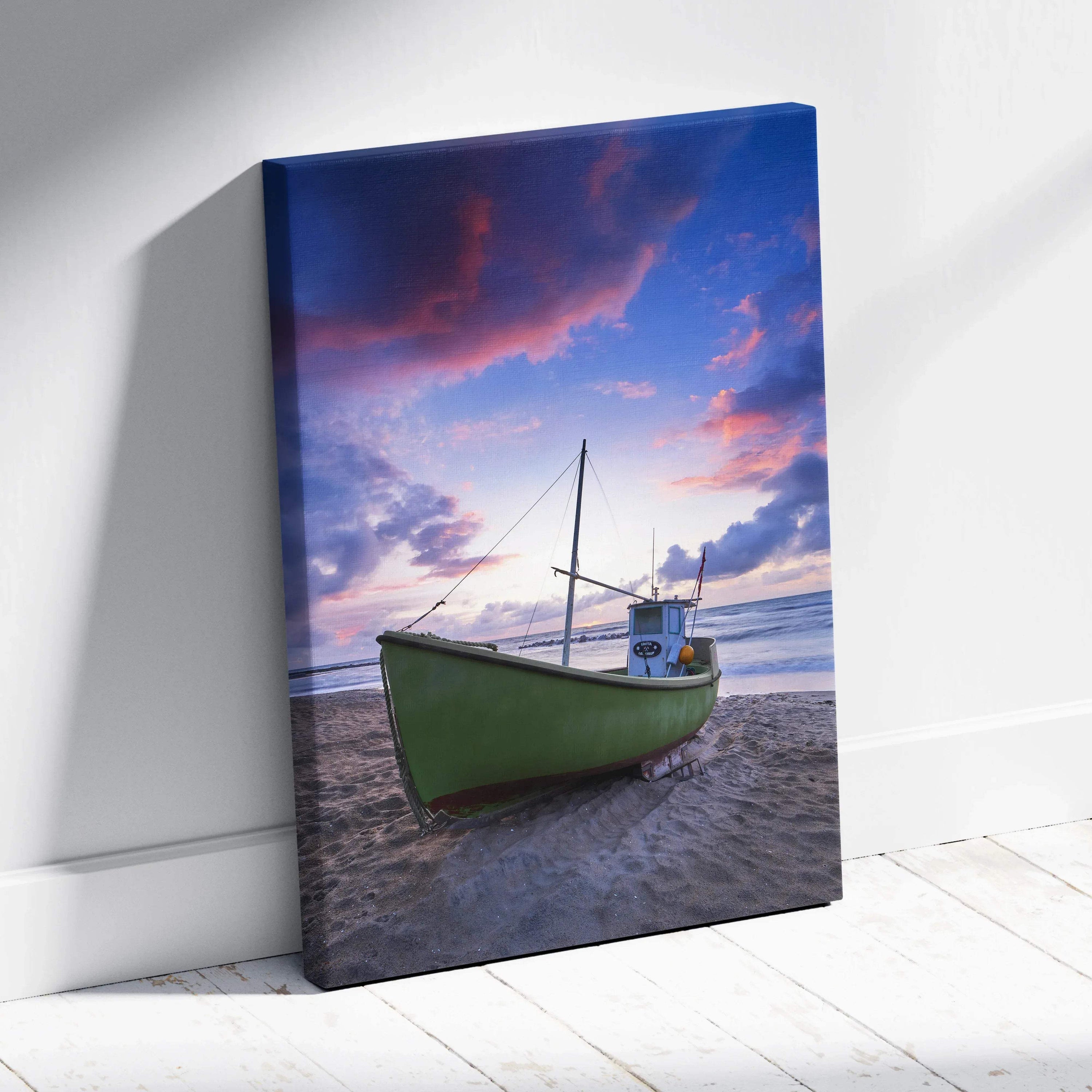 Canvas wall art featuring a green boat on a beach under a vibrant sunset sky.