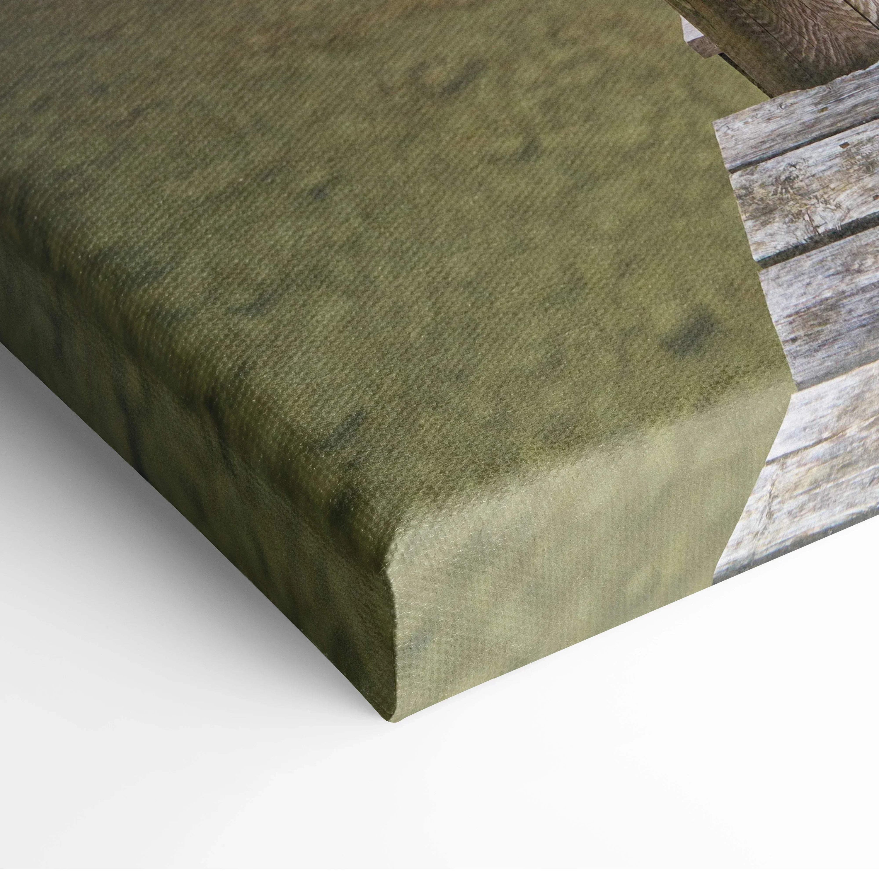 Close-up of textured green canvas corner showcasing vibrant beach sunset wall art detail.