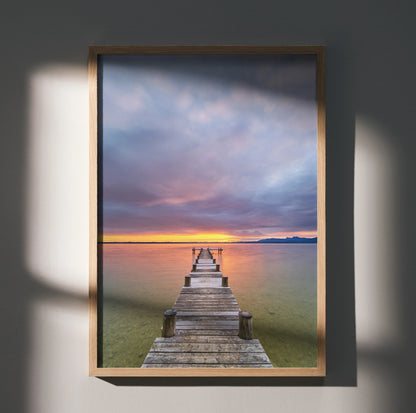 Serene beach sunset ocean poster featuring wooden pier extending into calm water, vertical wall art.