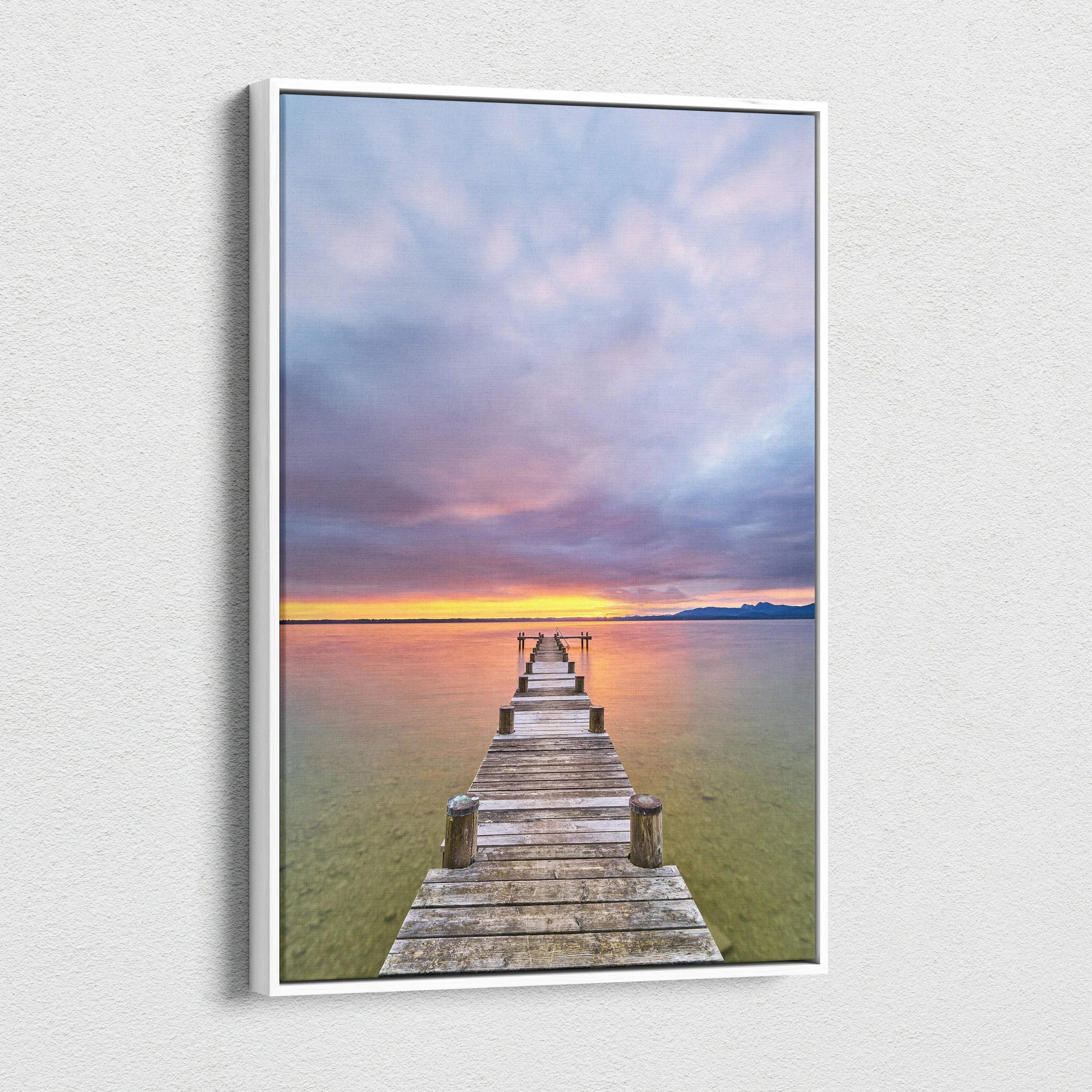 Vertical canvas wall art featuring a vibrant beach sunset with a wooden pier extending into calm water.
